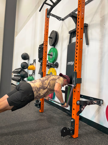 Man performs Banded Push-Ups on a PRx Performance Folding Squat Rack