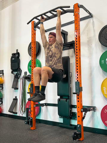 Man performing Hanging Knee Raises using PRx Performance PRO Squat Rack with Multi-Grip Bar