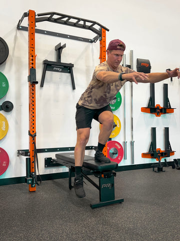 Man performing Single Leg Step Downs using a PRx Performance Folding Flat Bench.