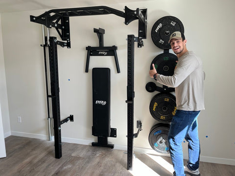 man standing with home gym set up
