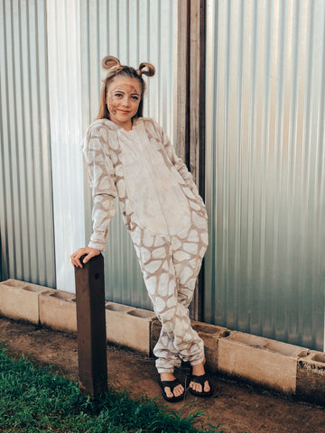giraffe costume girl leaning to side with pigtails and slippers metal wall