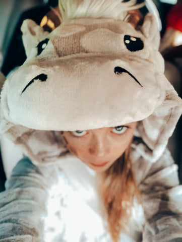 girl's selfie of a giraffe costume head blue eyes