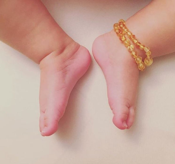 amber teething necklace on ankle