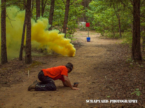 yellow smoke grenade during a scenario at boss paintball fields near charlotte nc