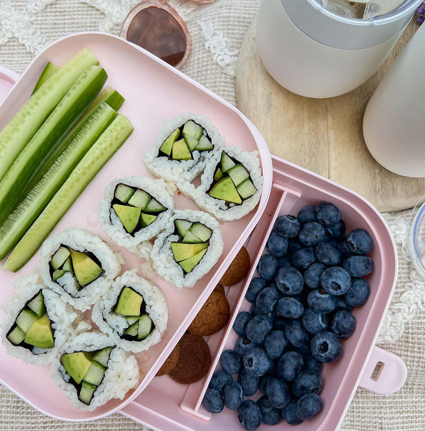 veggie rolls with fruit in storage container