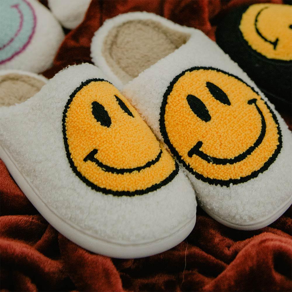 white fuzzy smiley face slippers