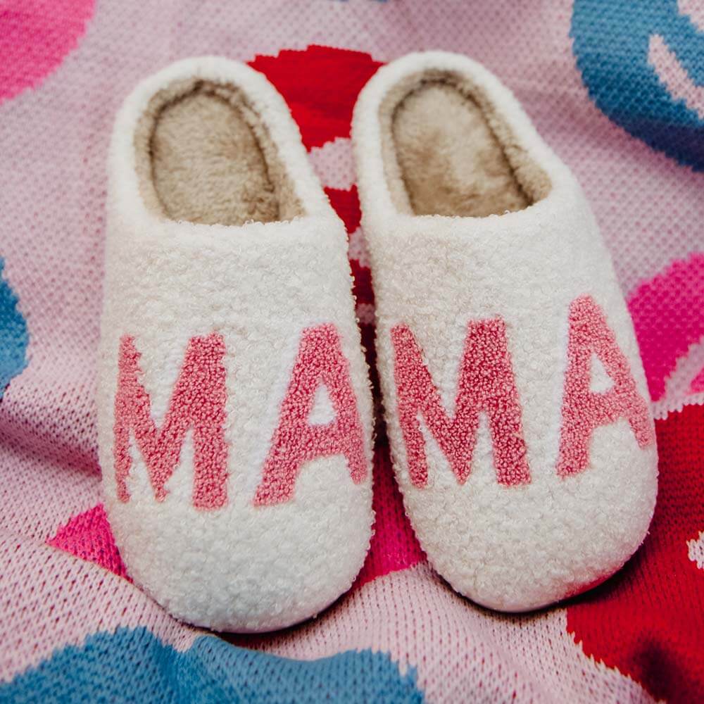 Fuzzy white “MAMA” house slippers as accessories for mom