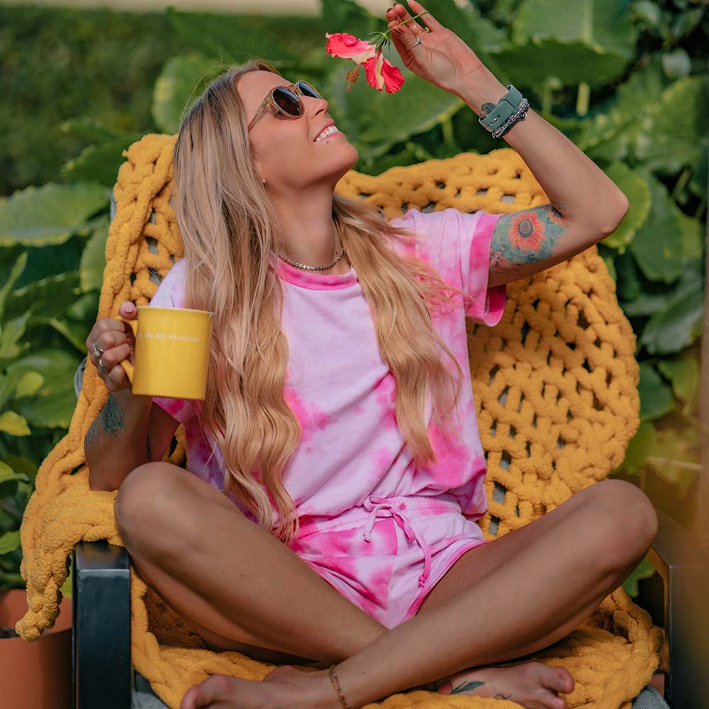 woman in pink tie-dye shirt and shorts