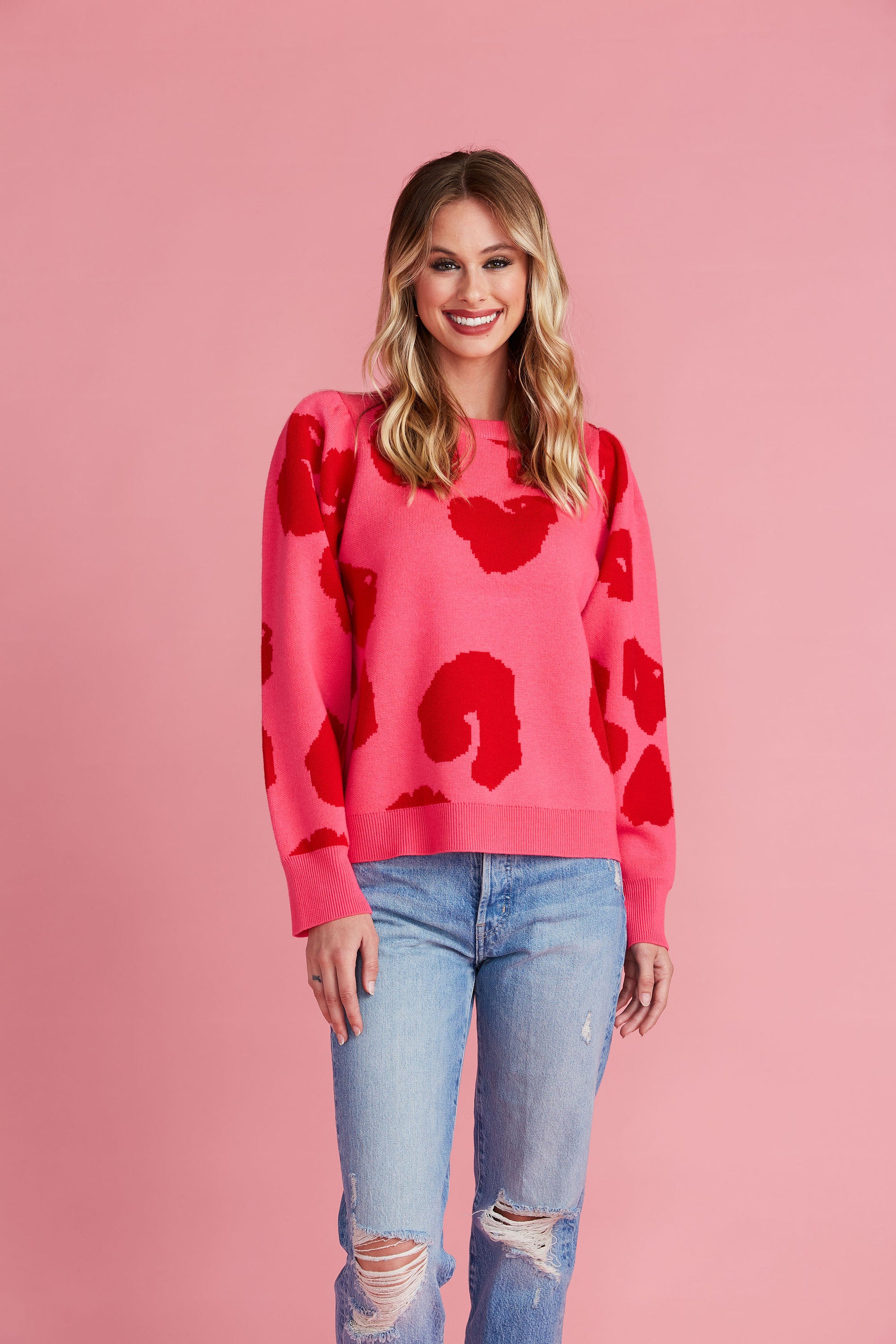 Woman in pink sweater with red leopard spots