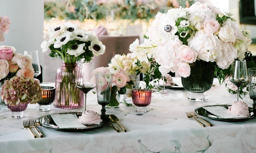 Anemone flowers and hydrangea bouquets arranged on a table.