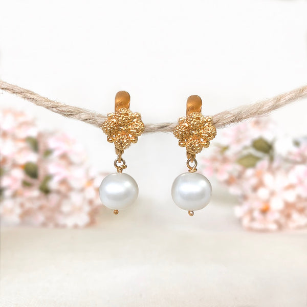 A pair of Estela Pearl Drop Earrings by AMAMI combines traces of gold jewelry-making history: the pre-colonial technique of granulation and the use of local gemstones (freshwater pearls).