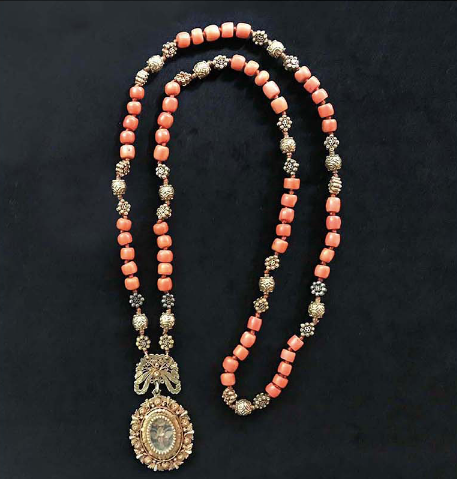 A tambourine necklace made with coral and gold beads and affixed with a relicario. (Photo from Faith and FIligree: 19th Century Hispano-Filipino Gold Jewellery)