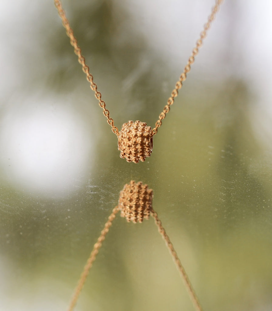 The minimalist Parug-Parug necklace from AMAMI Philippines is made from gold filigree by artisans in Ilocos Region, available on Cambio & Co.