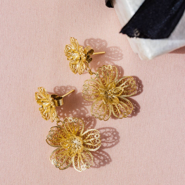 A pair of Filipino gold filigree earrings designed to mimic carnation flowers.