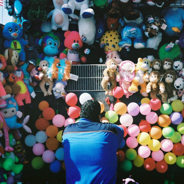 Man from back, staring at colorful balloons by Daniel Alvarez