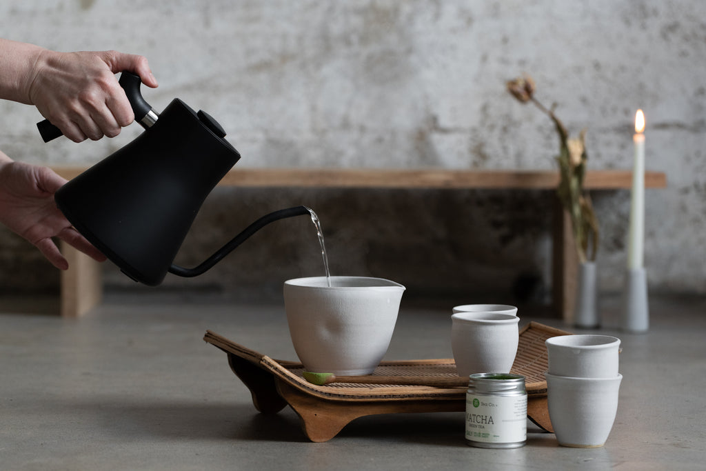 Pouring hot water into ceramic cup