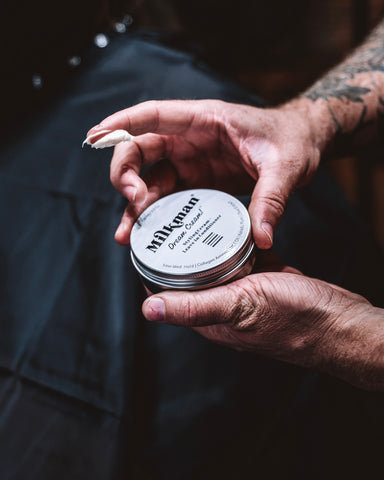 man holding dream cream styling cream pomade