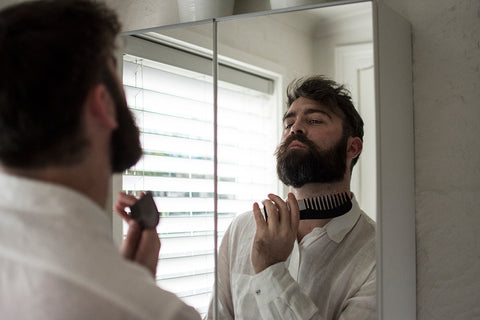 man combing beard up and out