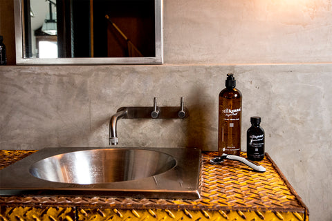 razor clear shave gel and after shave serum on industrial bathroom sink