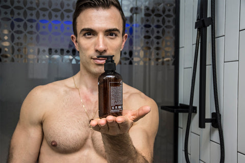 man with good skin care routine holding clear shave gel for his shaves which is great for sensitive skin