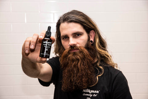 man holding milkman beard oil