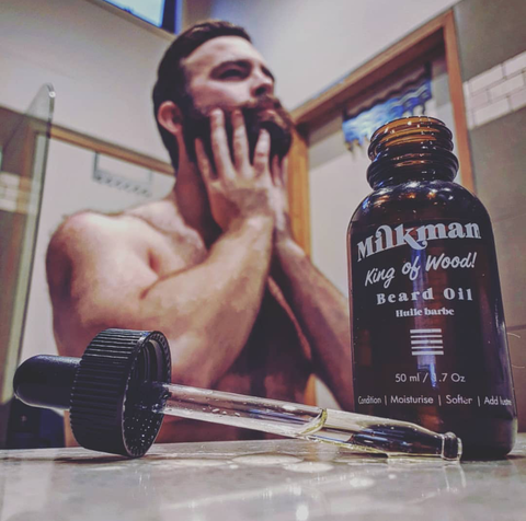 bearded man using beard oil