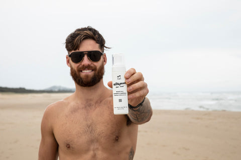 man holding 2 in 1 beard shampoo and conditioner