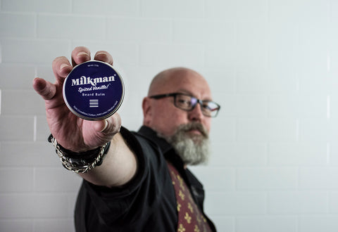 bearded man holding beard balm