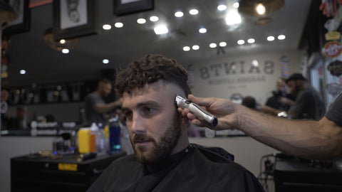 professional barber doing a mohawk fade