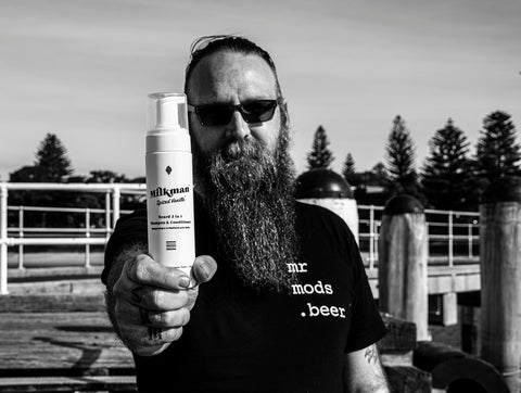 man holding milkman beard 2 in 1 shampoo and conditioner