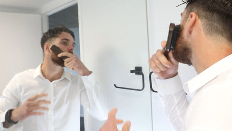 man brushing beard with milkman beard brush