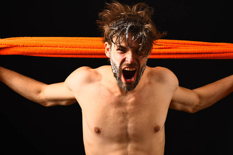 man shouting with towel not pat drying his hair