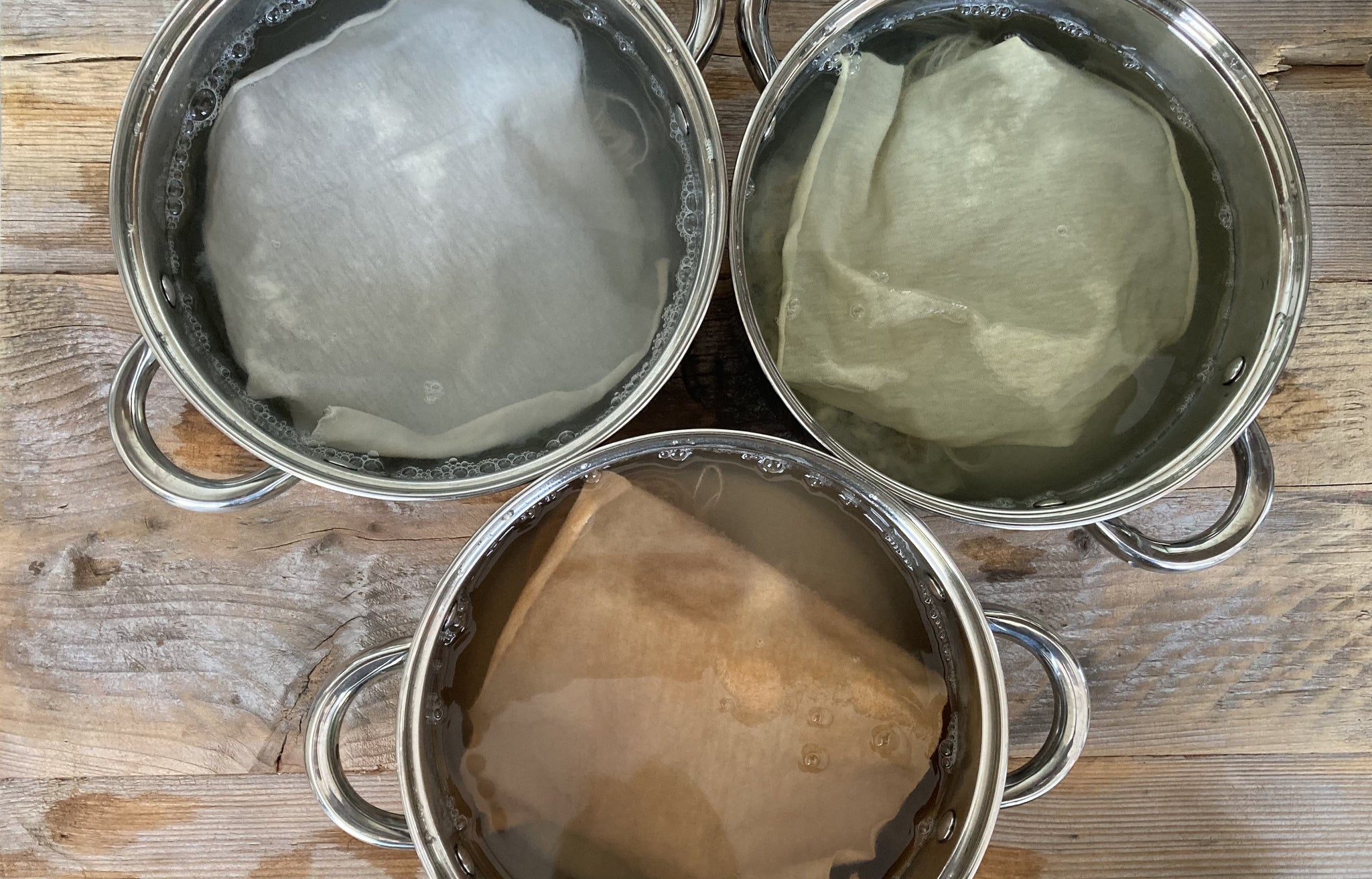 The three sets of samples steeping in alum and soda ash mordant baths