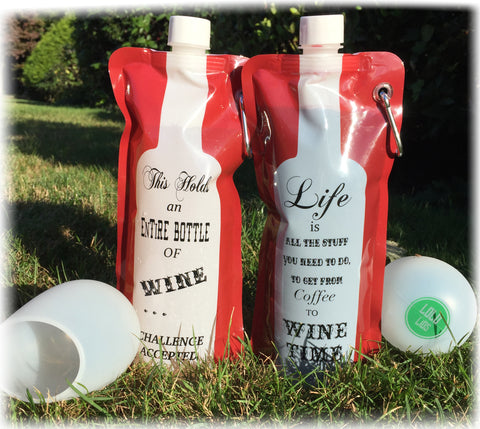 Two portable wine bags and cups outside on grass