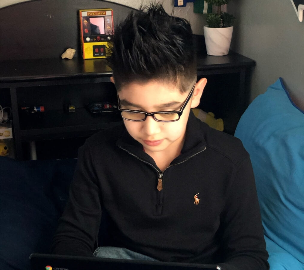 matthew wears his umizato kids blue blockers while online learning.