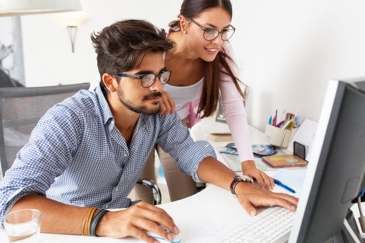 Female and male designers wearing round prescription glasses frames