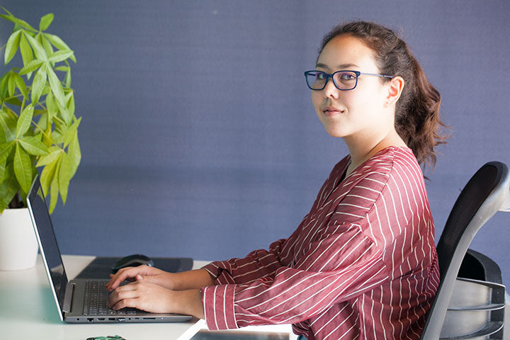 women on laptop computer glasses smile