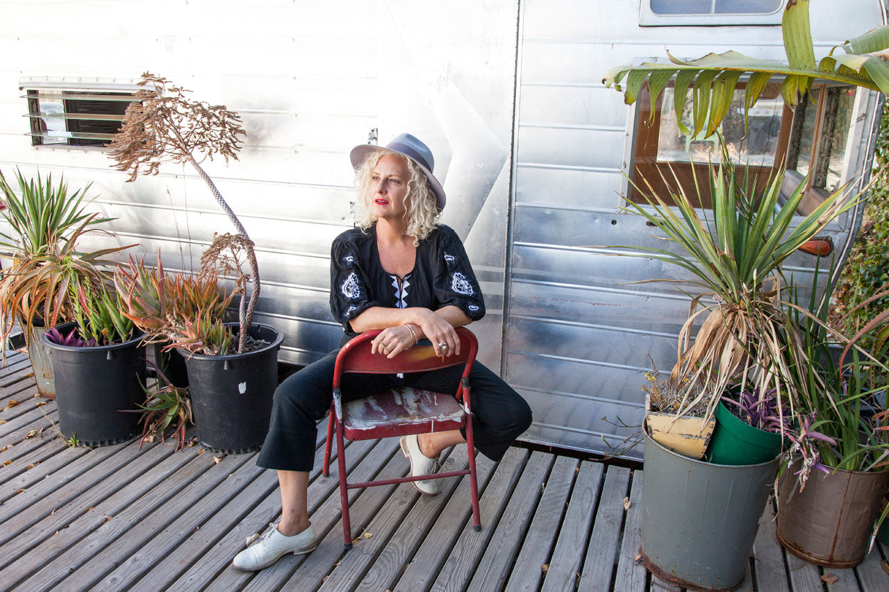 Leila Ligougne  muse Christine Wolheim wearing the Lola blouse in front of an airstream