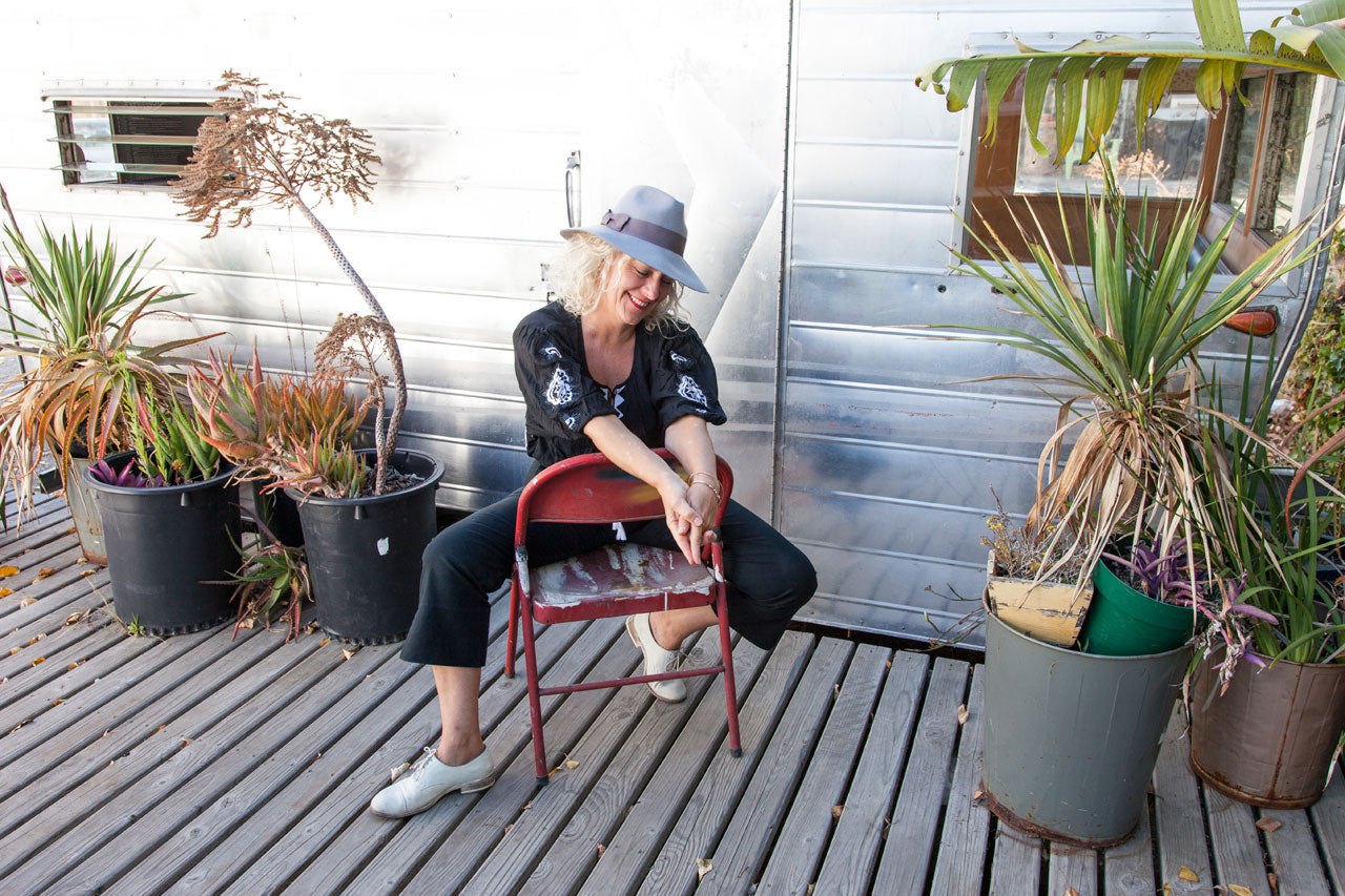 Leila Ligougne  muse Christine Wolheim wearing the Lola blouse in front of an airstream