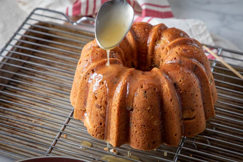 Grey Ghost Bakery German Rum Bundt Cake - Pouring Rum Glaze Over Cake