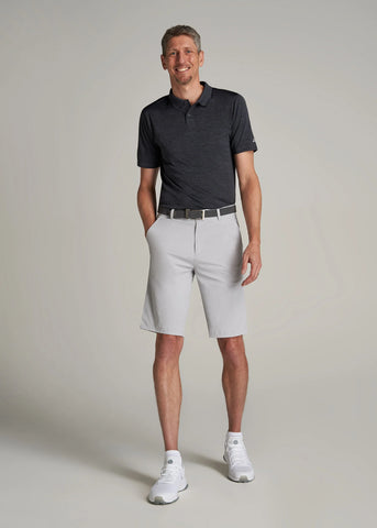 Man wearing dark grey polo shirt with light grey knee-length shorts