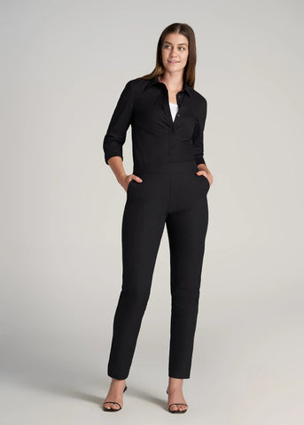 Woman standing wearing black button up dress shirt and black trousers for tall women