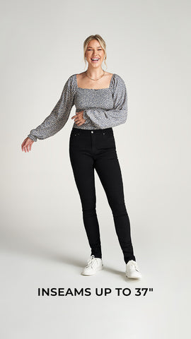 Woman wearing black jeans and blouse. Image text: inseams up to 37"