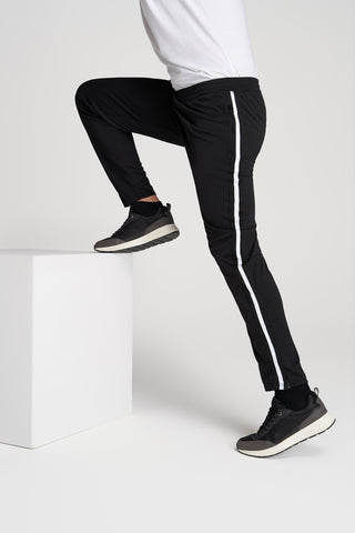 Closeup of man's long legs stepping up onto block in athletic pants