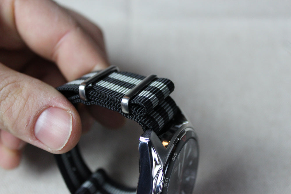 Folding the watch strap back into the buckle