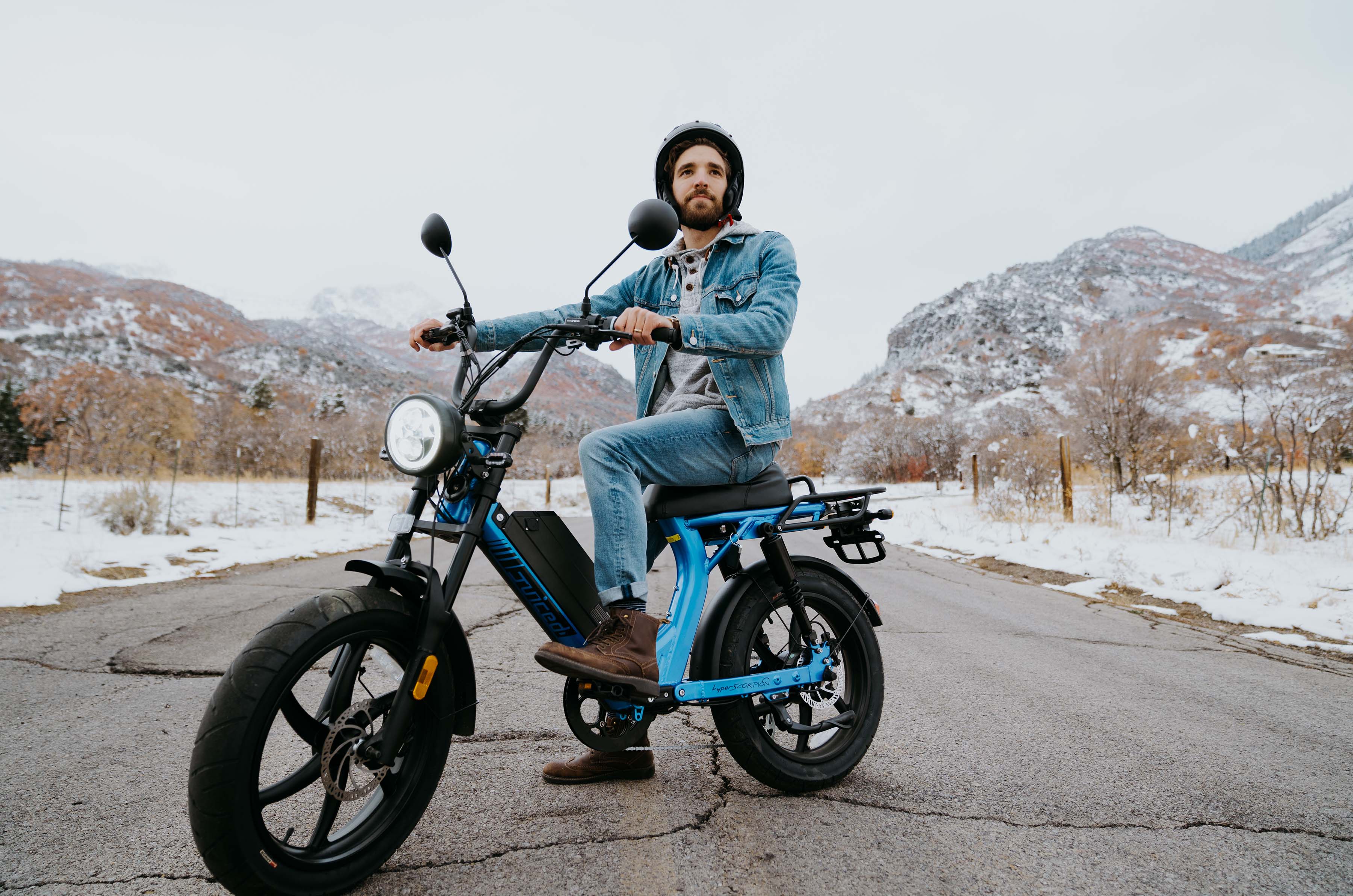 man sitting on a juiced hyperscorpion in the snowy countyside