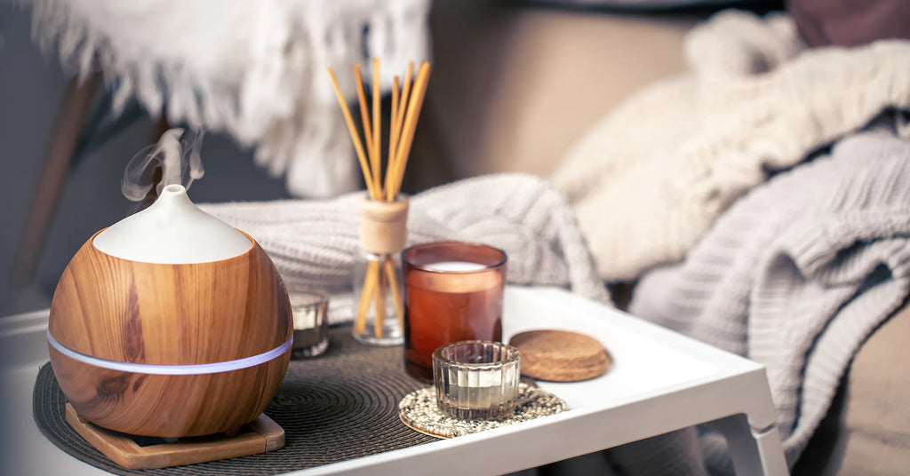 A cozy composition with an aroma diffuser and candles in a home interior