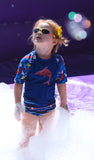 preschool aged girl wearing shark rash guard from Beau and Belle Littles and sunglasses