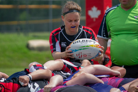 Emilie in action playing scrum half about to put the ball in the scrum