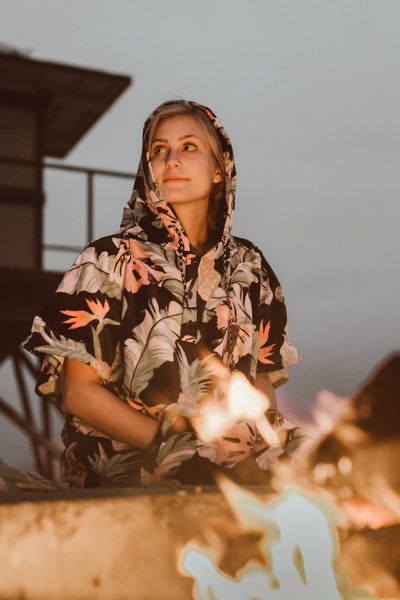 Women in sustainable poncho at bonfire located in Southern California